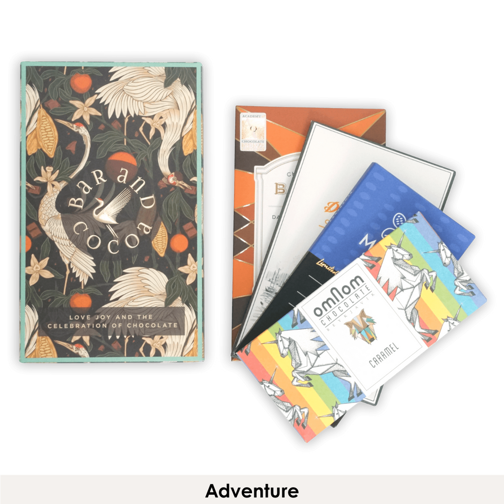 Colorful Omnom chocolate bars with rainbow unicorn designs in Discover Chocolate Club