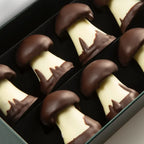 Michel Cluizel dark chocolate-covered white chocolate mushroom truffles with caramel in black gift box