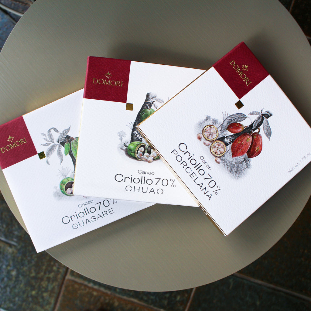 Domori Criollo chocolate bundle with 3 elegant white and red bars featuring cacao pod designs