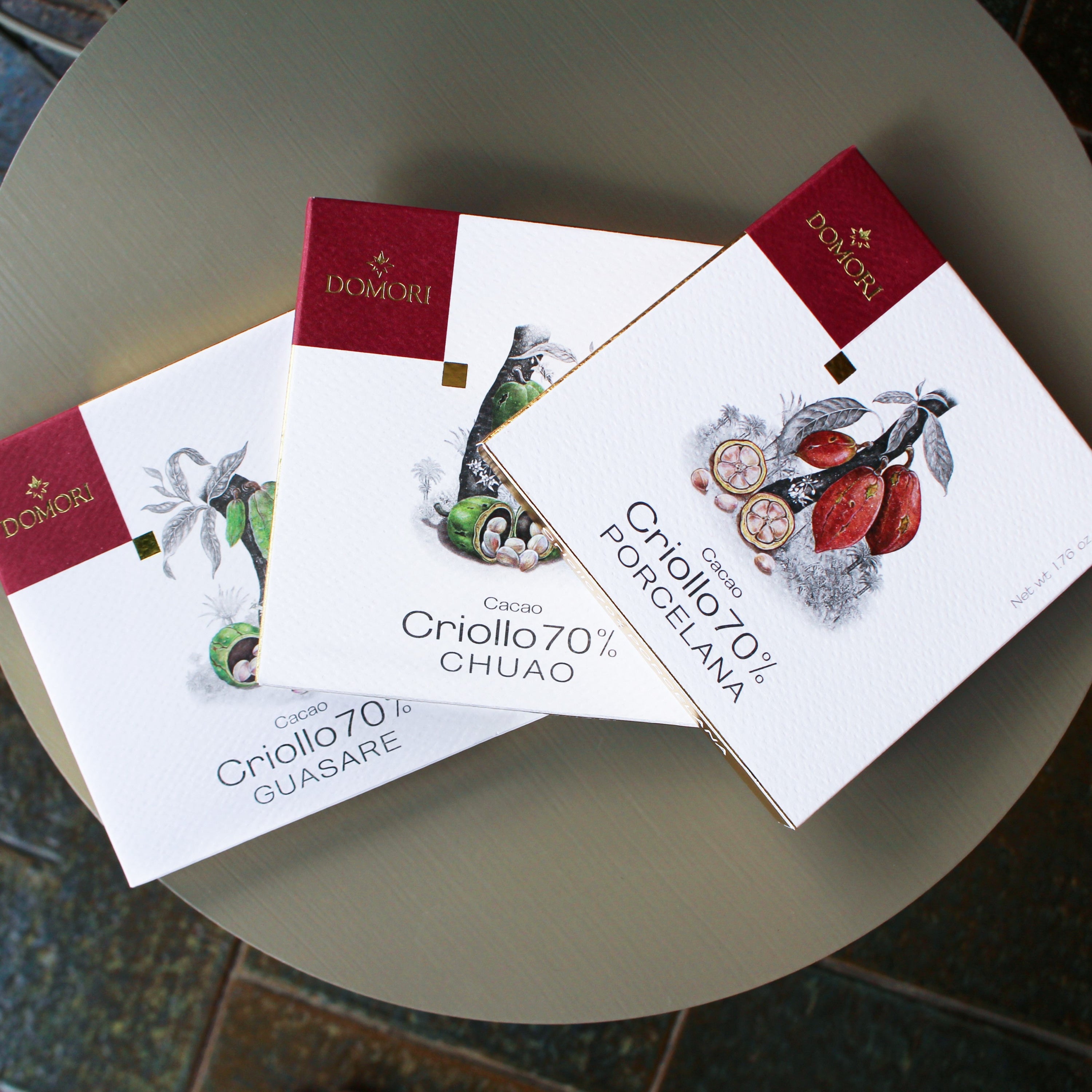 Domori Criollo chocolate bundle with 3 elegant white and red bars featuring cacao pod designs