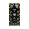 A black Feliu Chocolate 73% cacao bar box with yellow bird and floral patterns and Finca La Rioja Chiapas text.