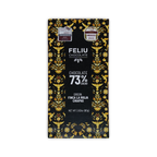 A black Feliu Chocolate 73% cacao bar box with yellow bird and floral patterns and Finca La Rioja Chiapas text.