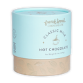French Broad Milk Hot Chocolate Mix in light blue cylindrical can with beige base and gold leaf patterns