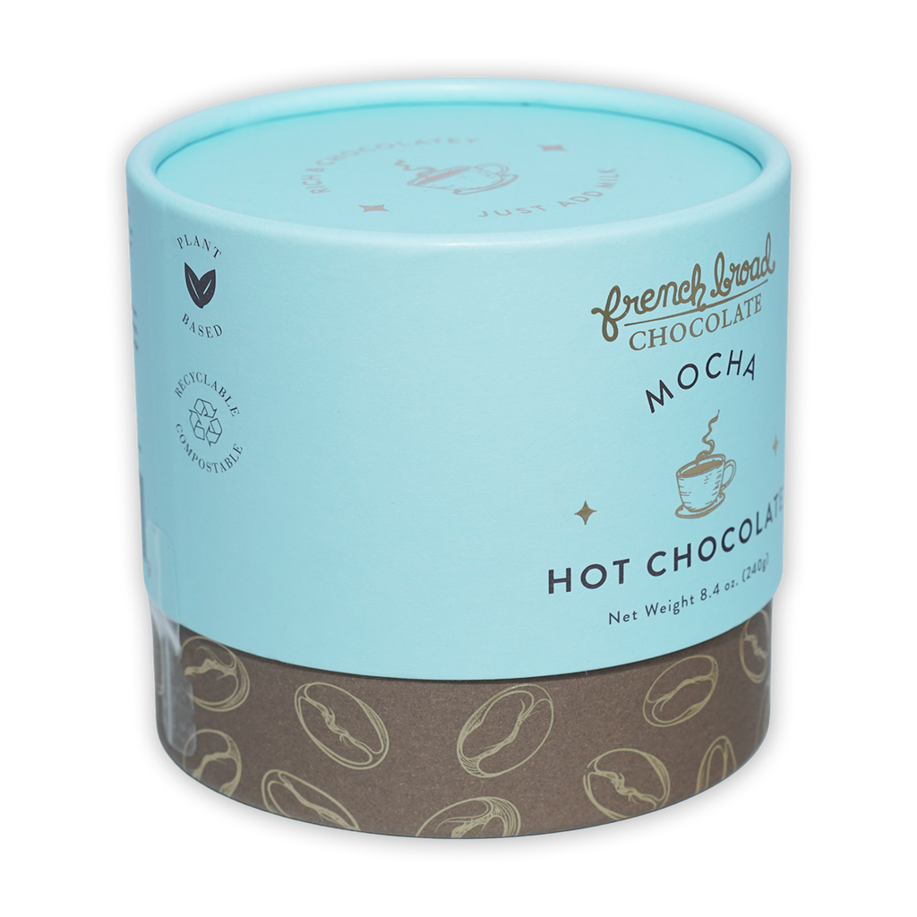 French Broad Mocha Hot Chocolate in light blue cylinder with coffee beans