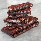 Mirzam Mango Sticky Rice Milk Chocolate 52% bar stack with nuts and candy