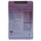 The back of a purple resealable pouch of Pure Ceremonial Cacao 'Illuminating India' The packaging features product details, nutritional facts, preparation instructions, and a QR code.