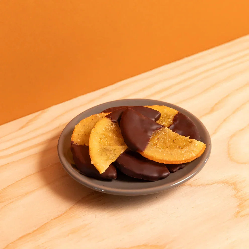 Ranger Candied Oranges w/ Spices in Dark Chocolate on gray dish