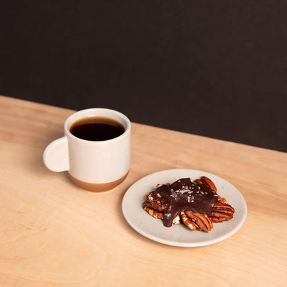 White ceramic mug of Ranger Chocolate Turtle Pecans w/ Caramel black coffee