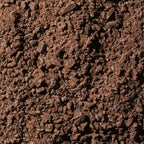 Dark brown coarse coffee grounds in Ritual Mid Mountain 65% chocolate