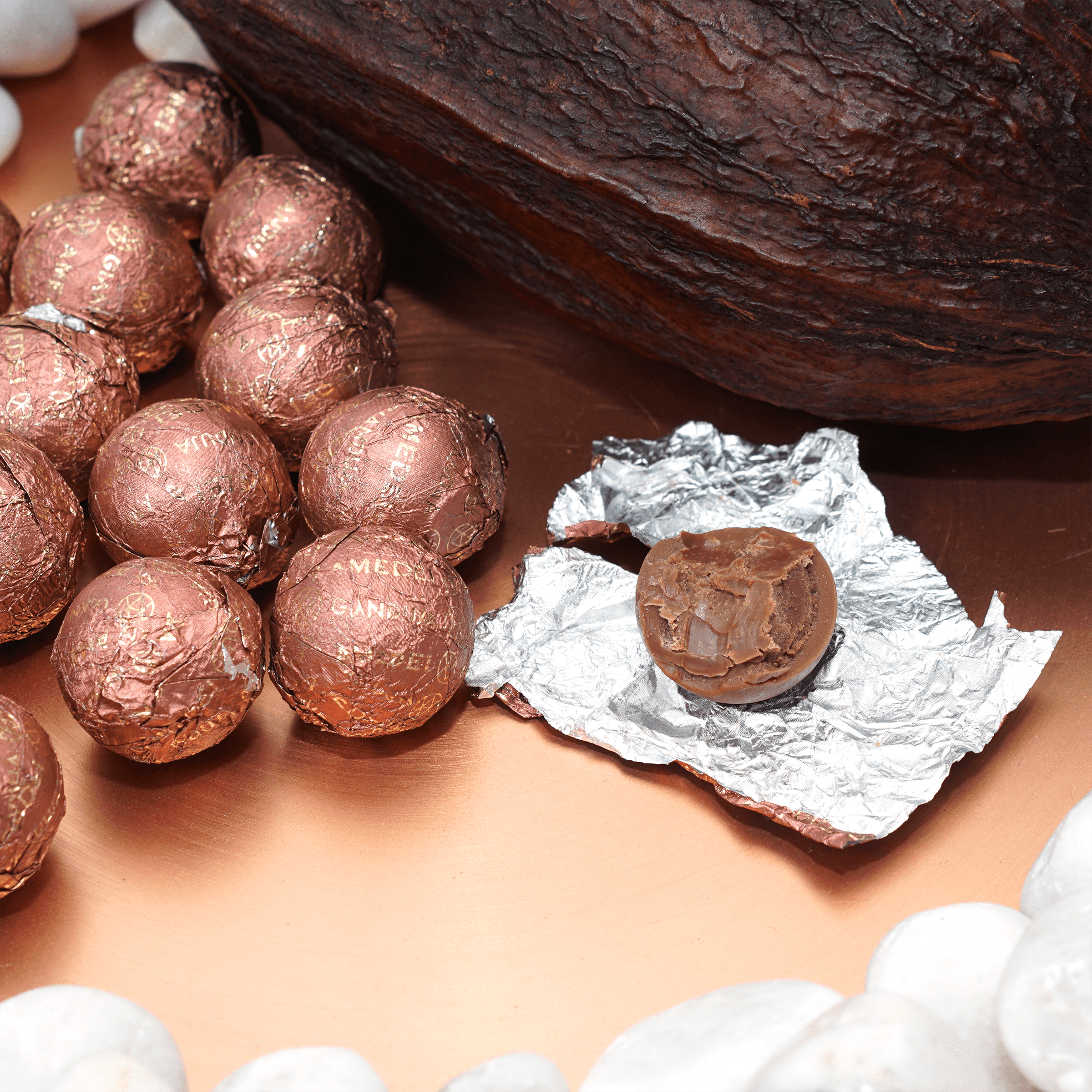 Amedei Pralines Milk w/ Crema Toscana round dark chocolate truffle in rose gold foil
