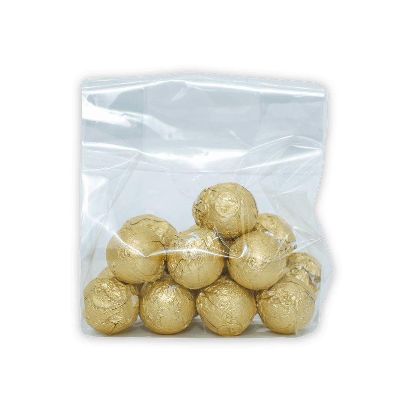 Amedei pralines white with hazelnut filling in clear bag of golden truffles