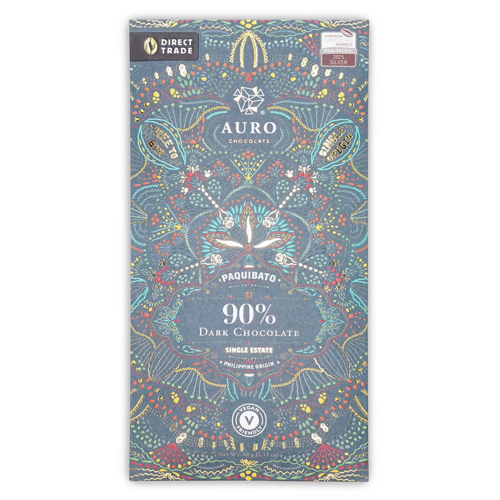 A dark blue Auro Chocolate wrapper with colorful patterns, reading Paquibato 90% Dark Chocolate, on a white background.