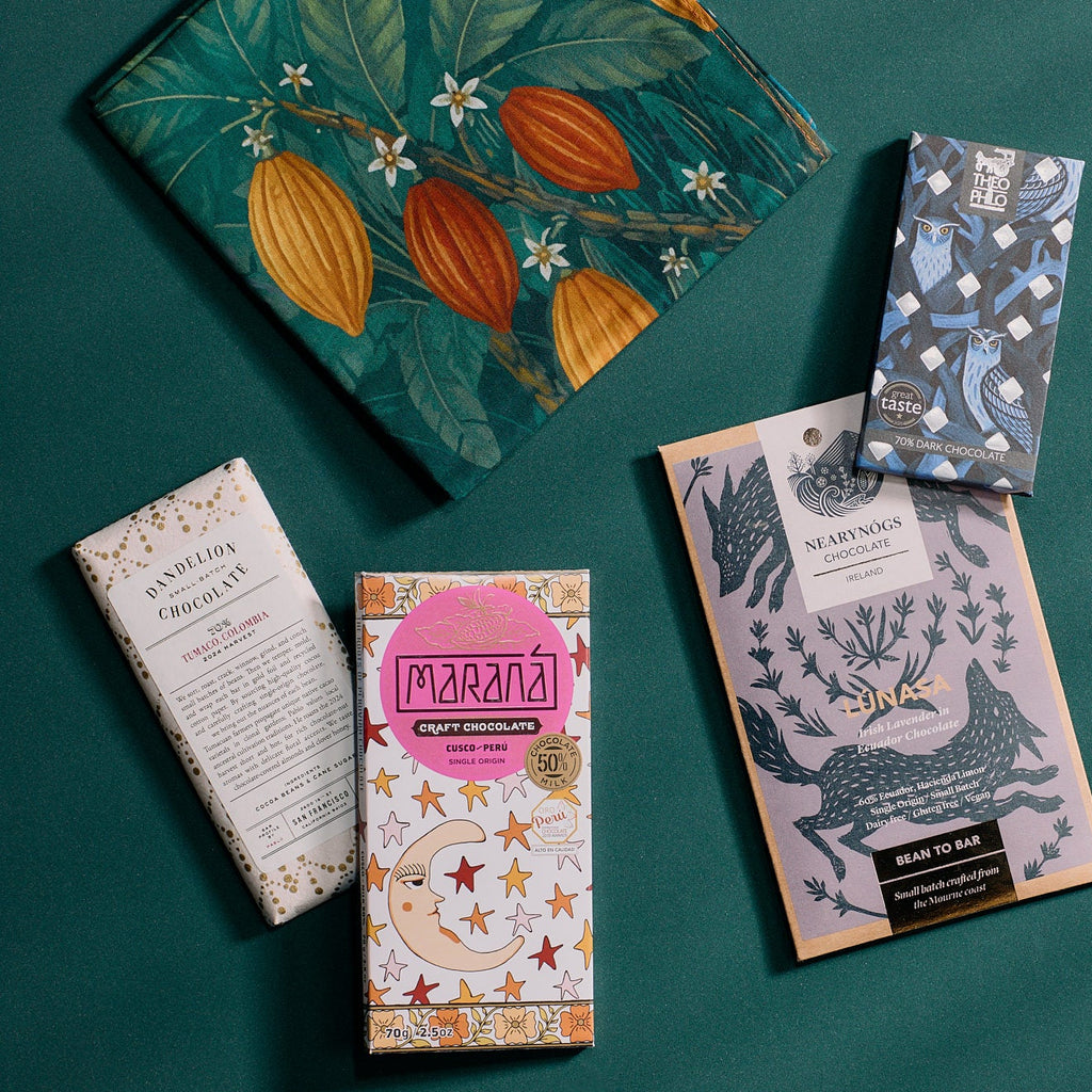 70 cm cotton furoshiki gift wrap showing a crane, cacao pod, and botanical print beside craft chocolate bars
