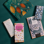 70 cm cotton furoshiki gift wrap showing a crane, cacao pod, and botanical print beside craft chocolate bars