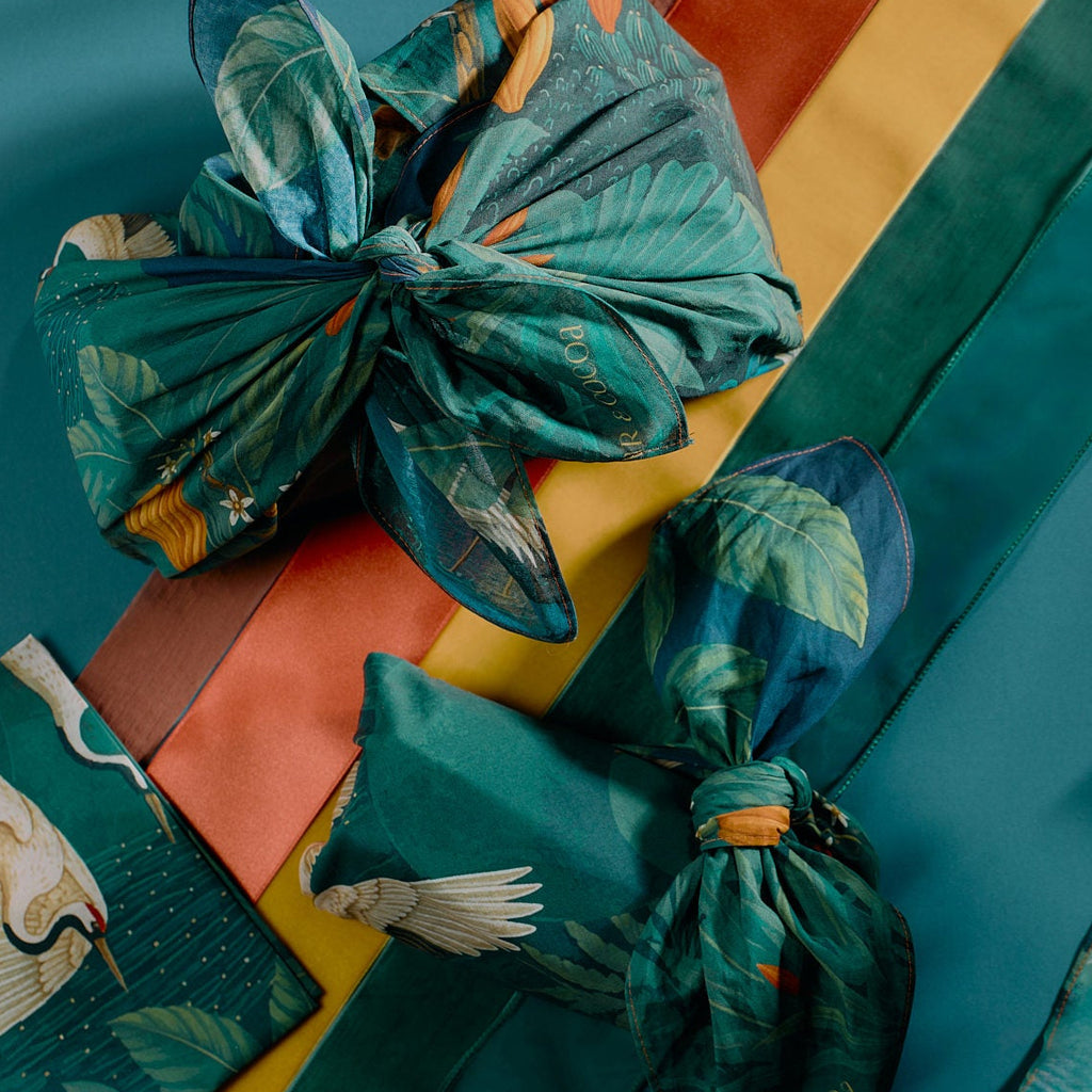 Bar & Cocoa cotton furoshiki gift wrap tied around chocolate gifts, with a deep green crane and botanical print