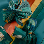 Bar & Cocoa cotton furoshiki gift wrap tied around chocolate gifts, with a deep green crane and botanical print