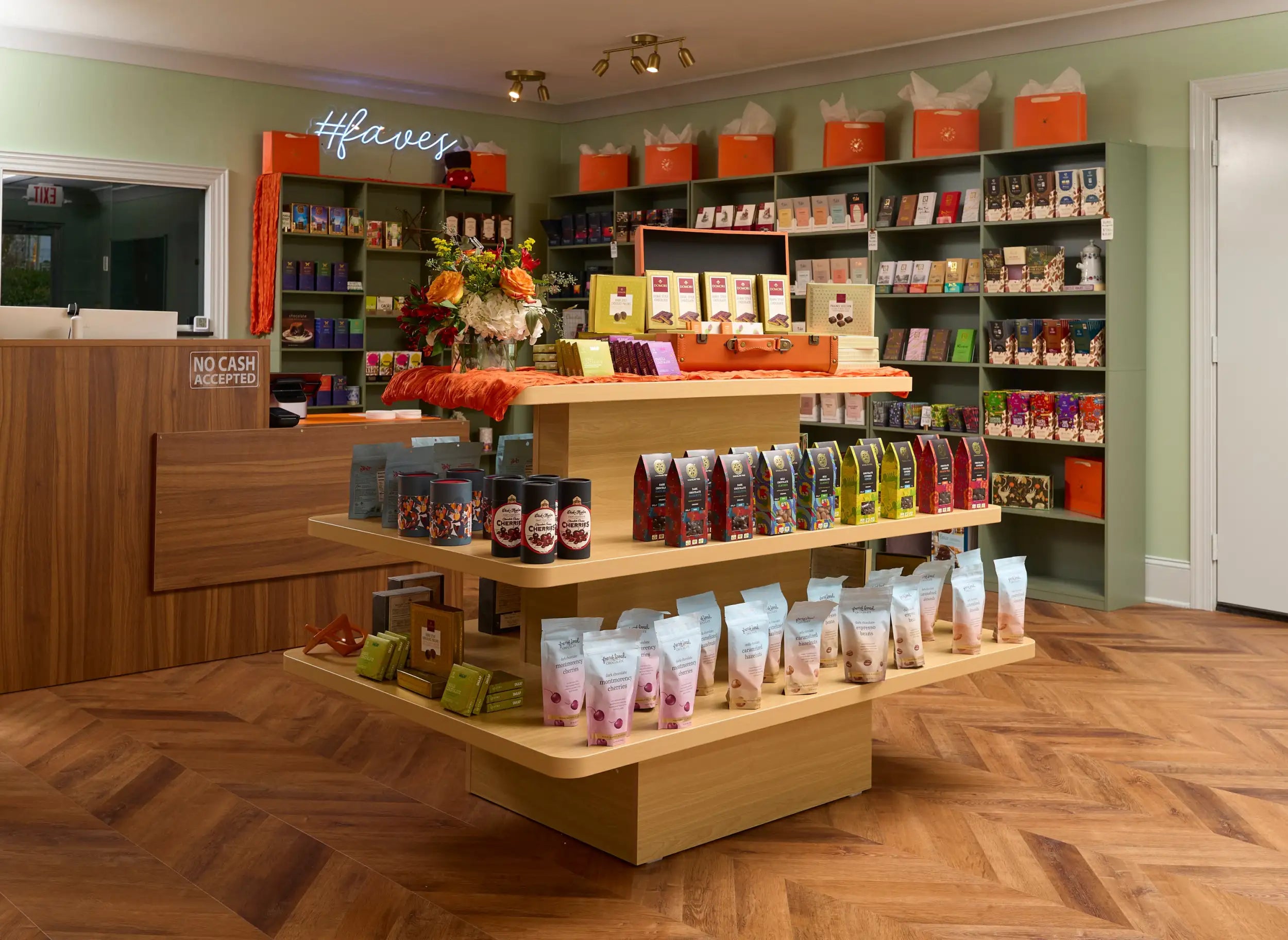 Wooden display shelf with multiple tiers holding various packaged goods