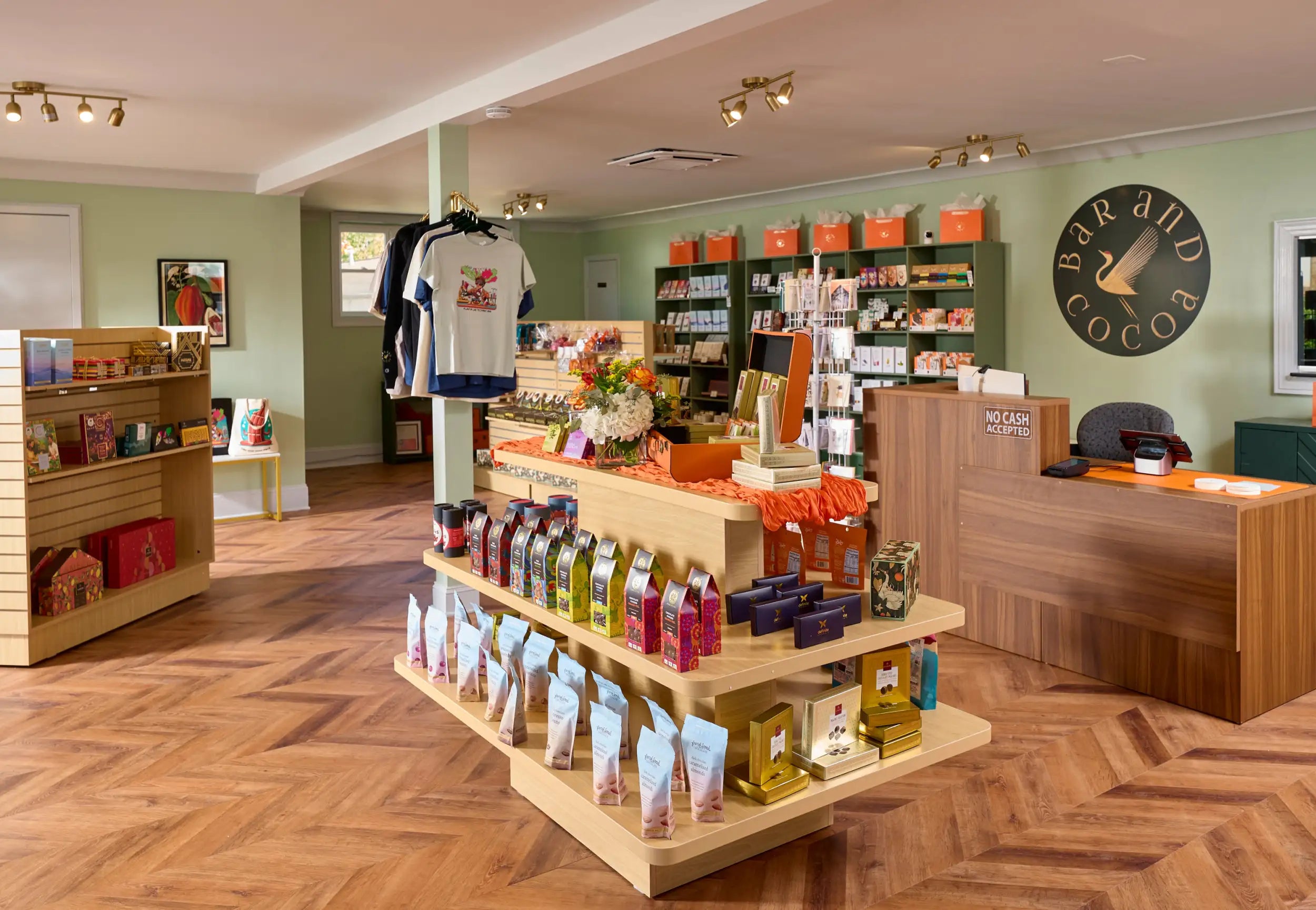 Wooden display shelf with multiple tiers holding an assortment of colorful packaged goods.