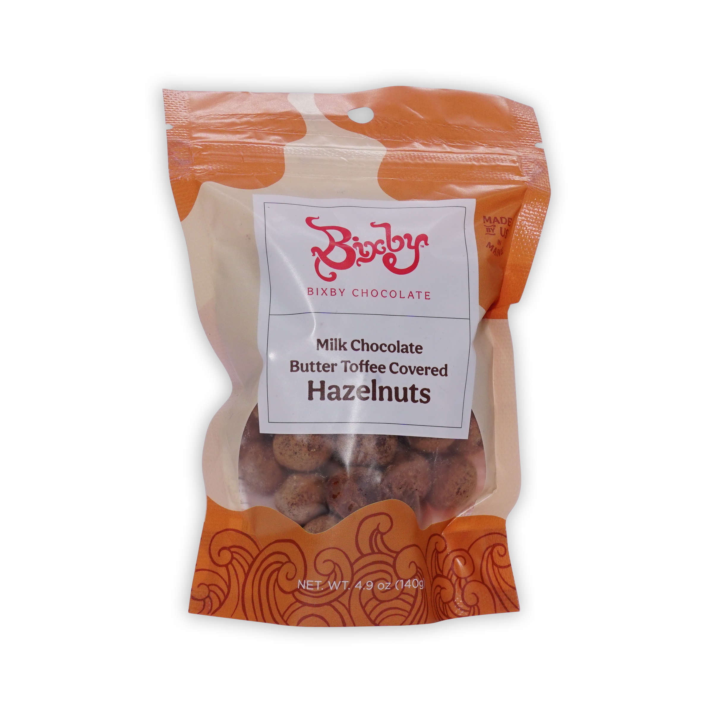 Orange and cream Bixby pouch of milk chocolate butter toffee covered hazelnuts with a window showing the nuts.