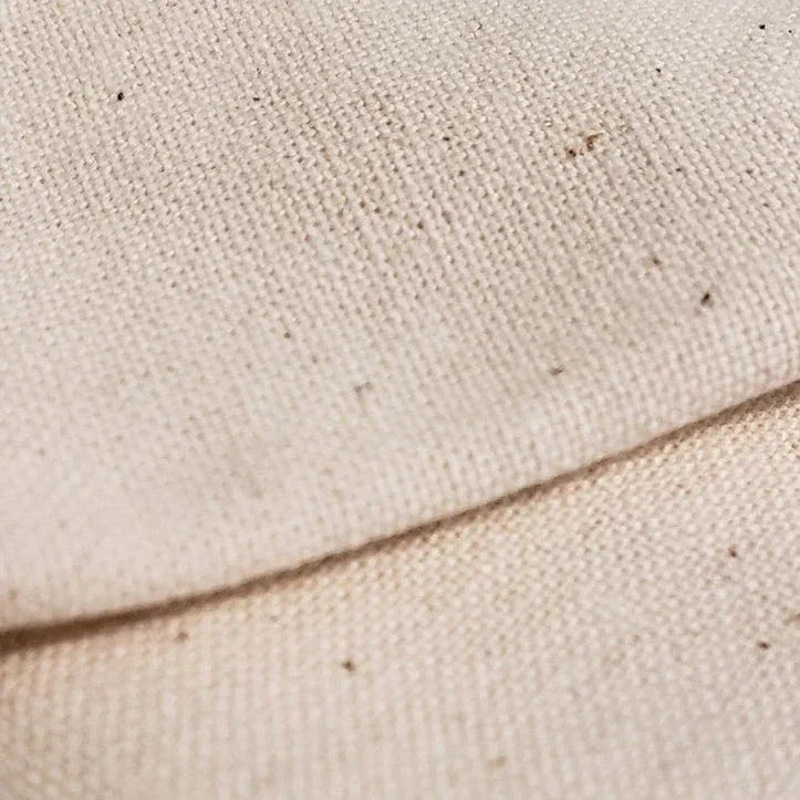 Beige canvas eco tote bag fabric with woven texture and dark specks
