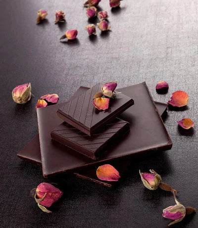 Dark chocolate bars with a smooth, glossy surface and subtle diagonal grooves.