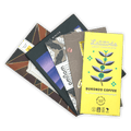 Bright yellow Latitude craft coffee chocolate bar with teal purple plant design
