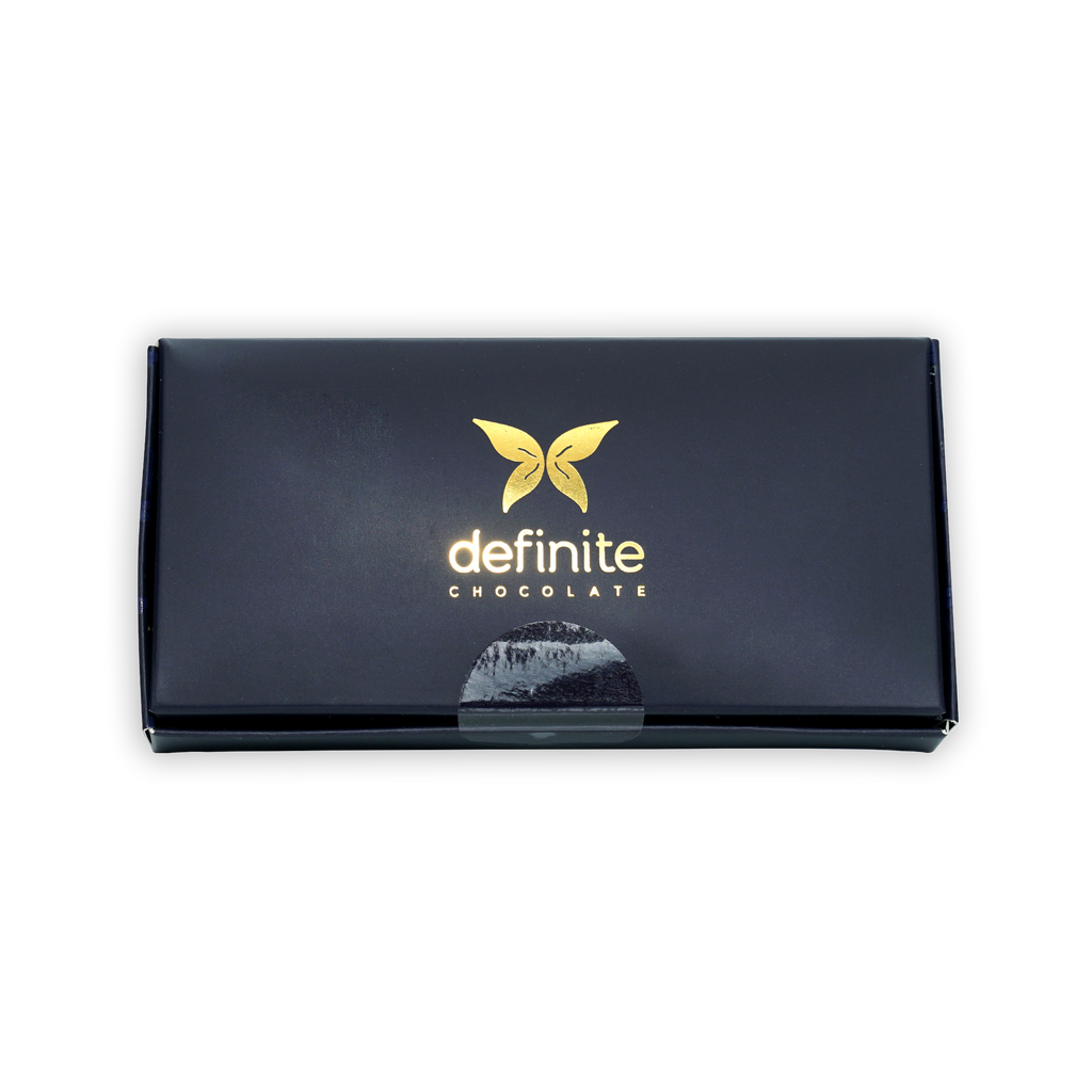 Definite 100% dark chocolate covered dates with macadamia, black box with gold butterfly logo