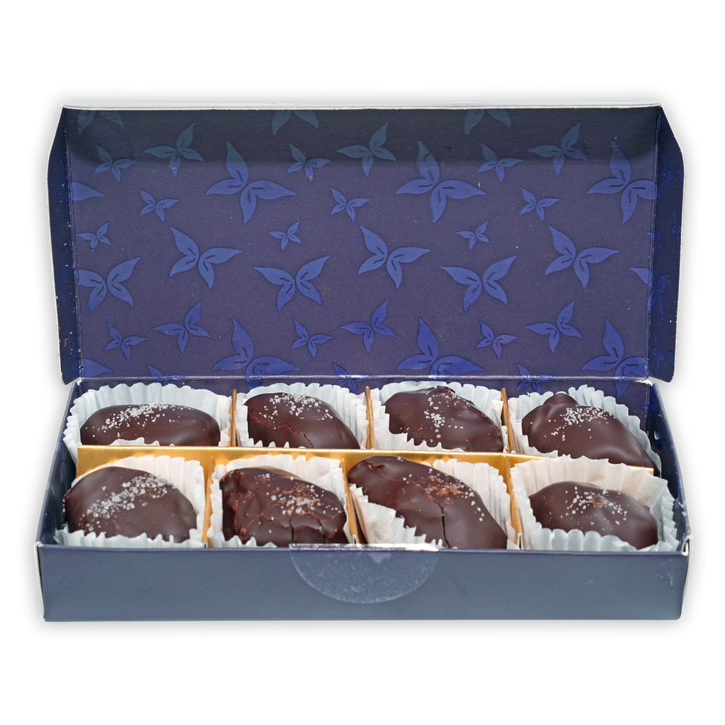Definite 100% dark chocolate covered dates with macadamia in blue butterfly box