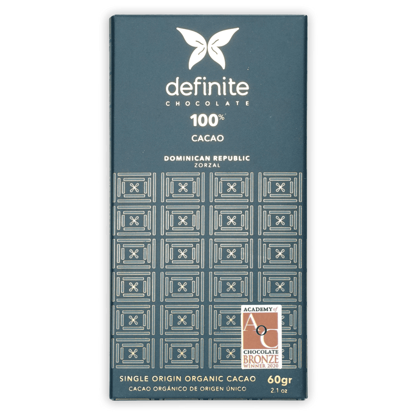 Definite Zorzal 100% dark teal chocolate bar wrapper with white text and geometric patterns