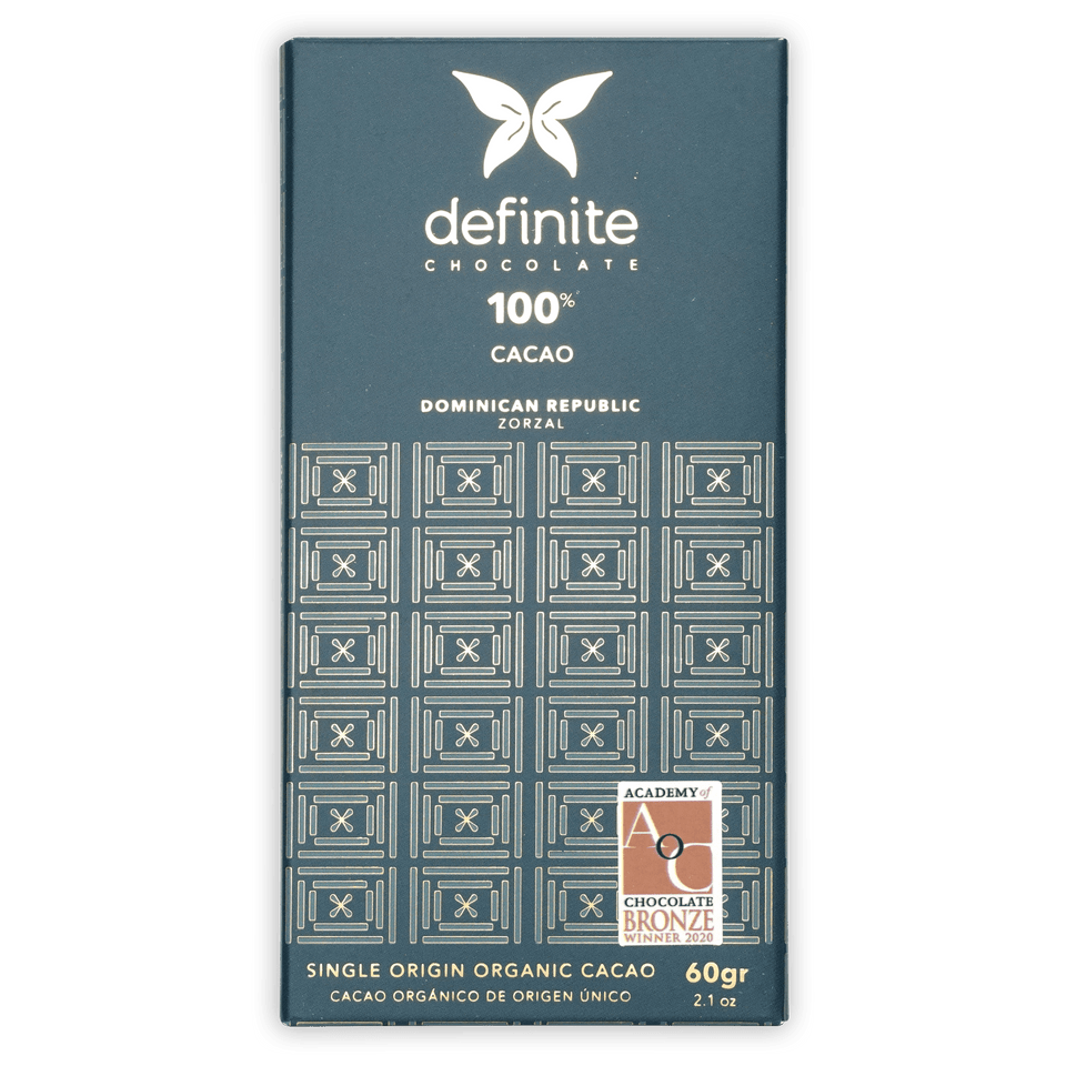 Definite Zorzal 100% dark teal chocolate bar wrapper with white text and geometric patterns
