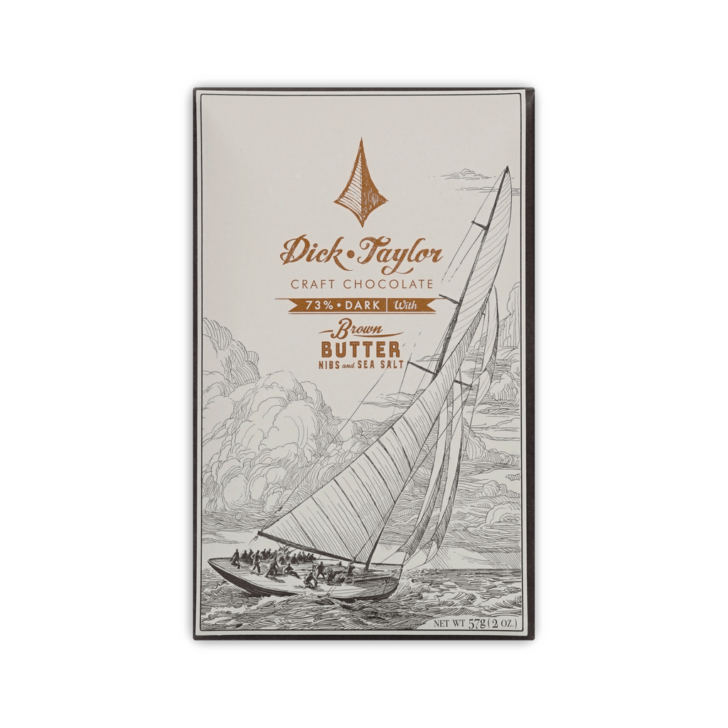 Dick Taylor Craft Chocolate 73% Dark with Brown Butter, Nibs and Sea Salt bar in cream box with a sailboat illustration, 57g.