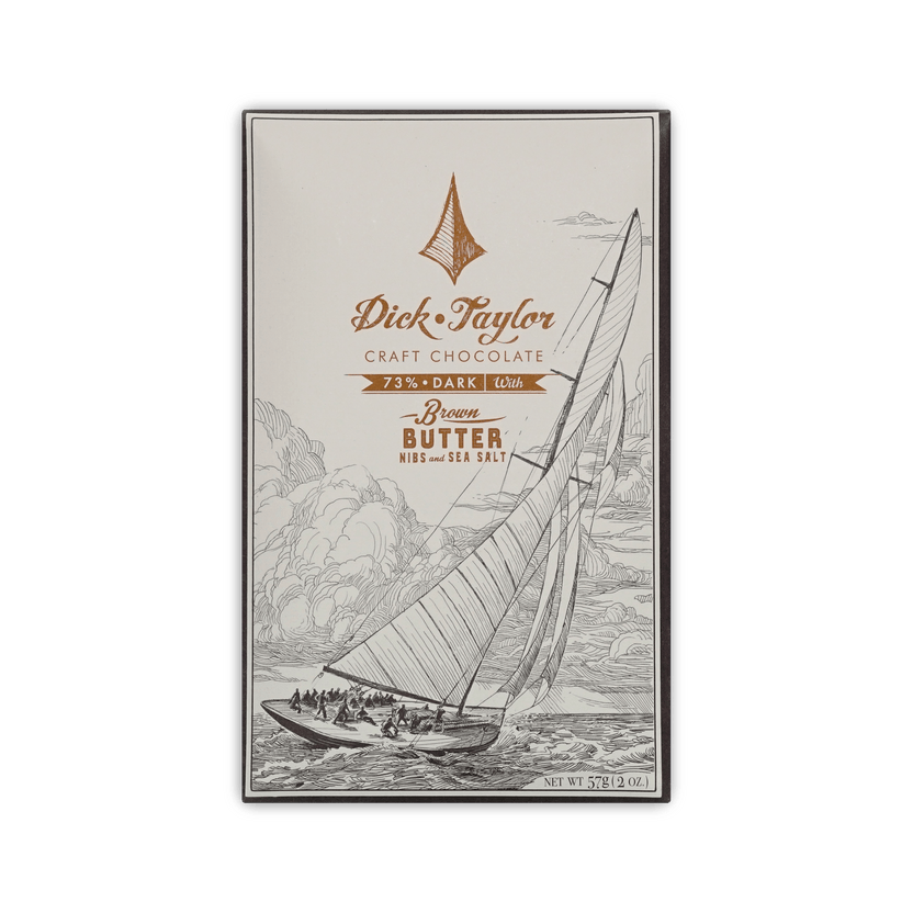 Dick Taylor Craft Chocolate 73% Dark with Brown Butter, Nibs and Sea Salt bar in cream box with a sailboat illustration, 57g.