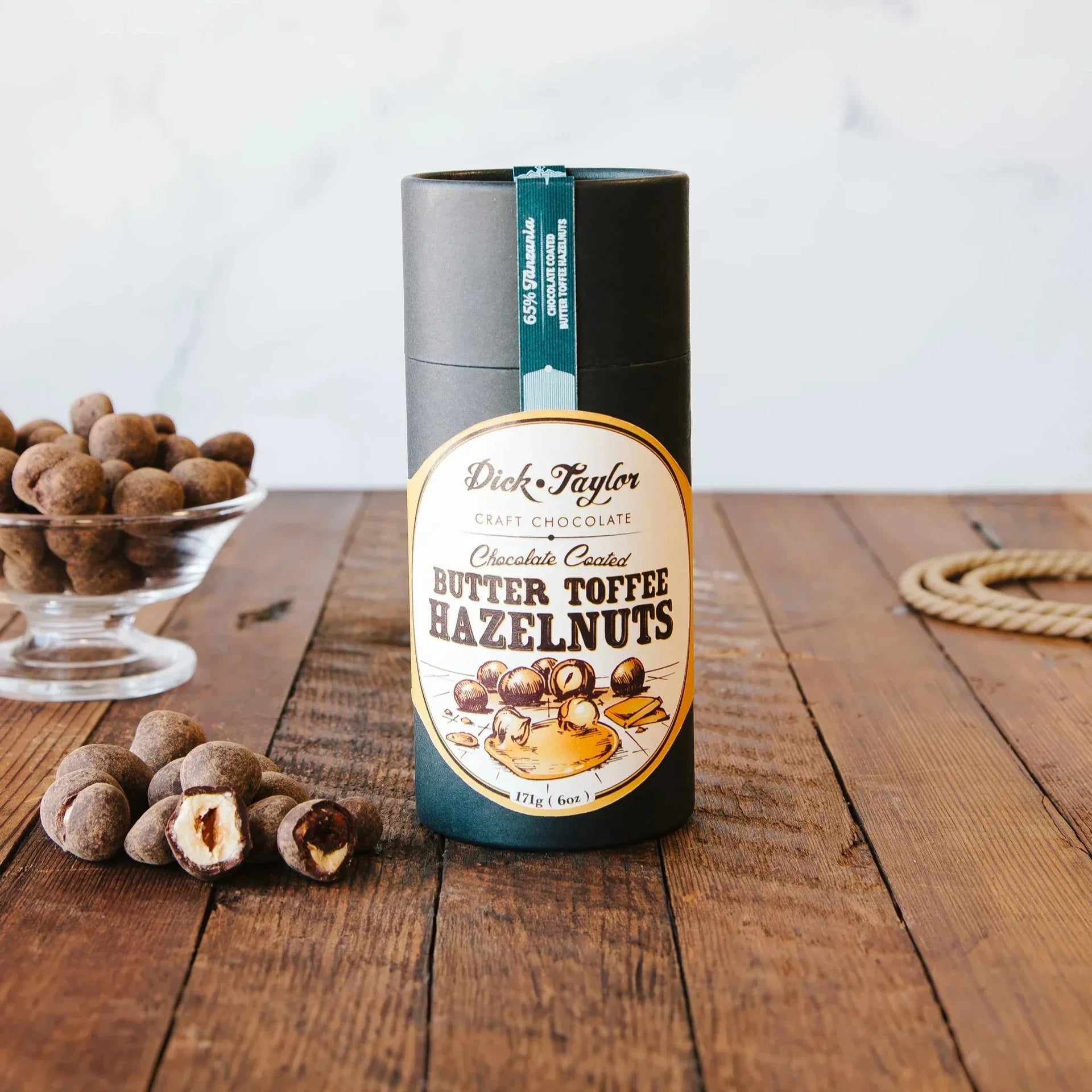 Dick Taylor 65% chocolate coated butter toffee hazelnuts in sleek black tin