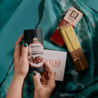 Hands holding Dick Taylor chocolate-coated cherries with Belvie, Pralus and Guido Gobino chocolates