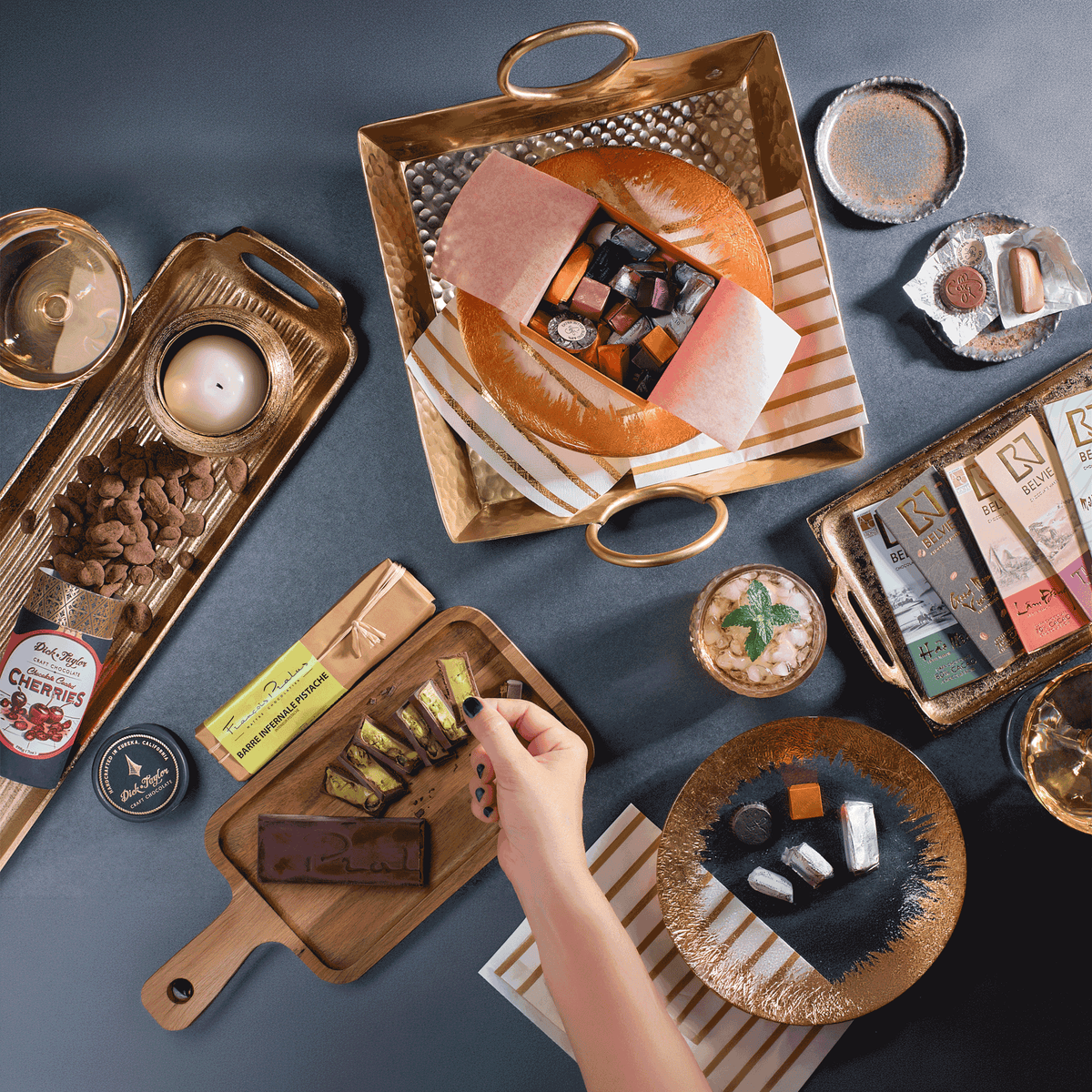 Dinner Party Hero chocolate bundle styled on gold trays for sharing
