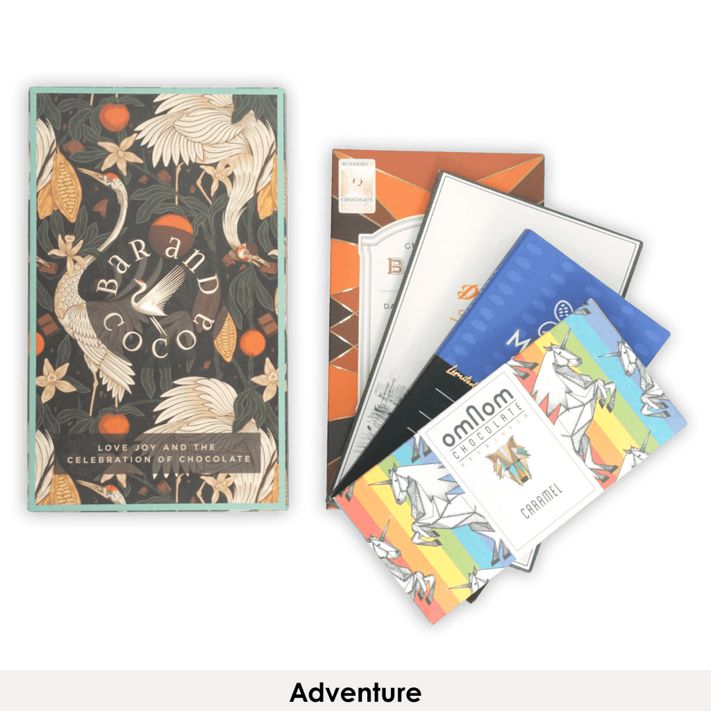 Colorful Omnom chocolate bars with rainbow unicorn designs in Discover Chocolate Club
