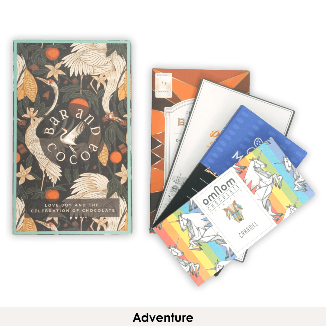 Colorful Omnom chocolate bars with rainbow unicorn designs in Discover Chocolate Club