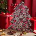 Domori tree-shaped advent calendar on a holiday table, with wrapped chocolates and a plate of pieces in front
