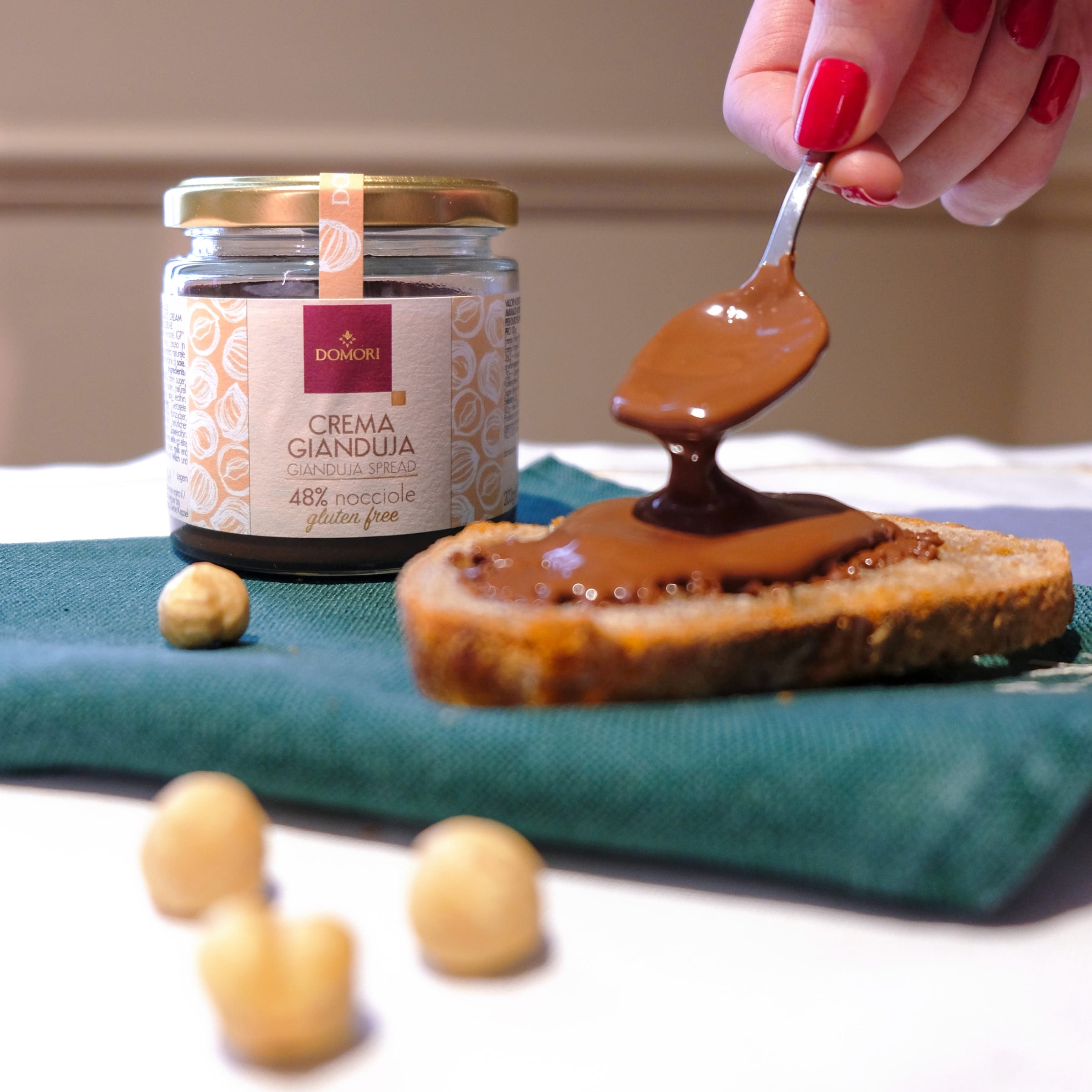 Domori Crema Gianduja 48% hazelnut spread jar on bread