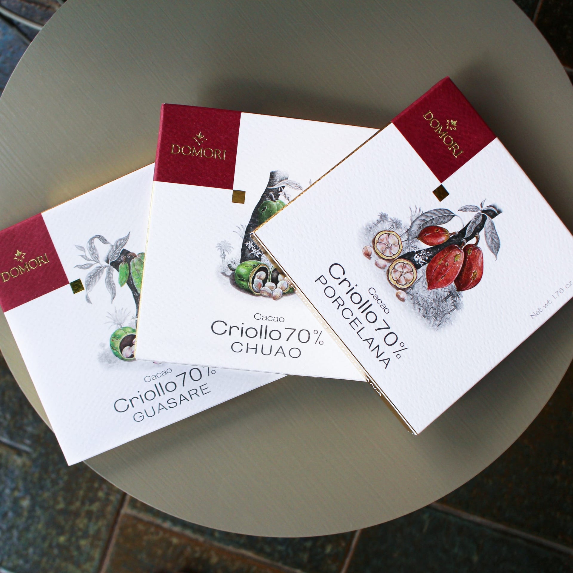 Domori Criollo chocolate bundle with 3 elegant white and red bars featuring cacao pod designs