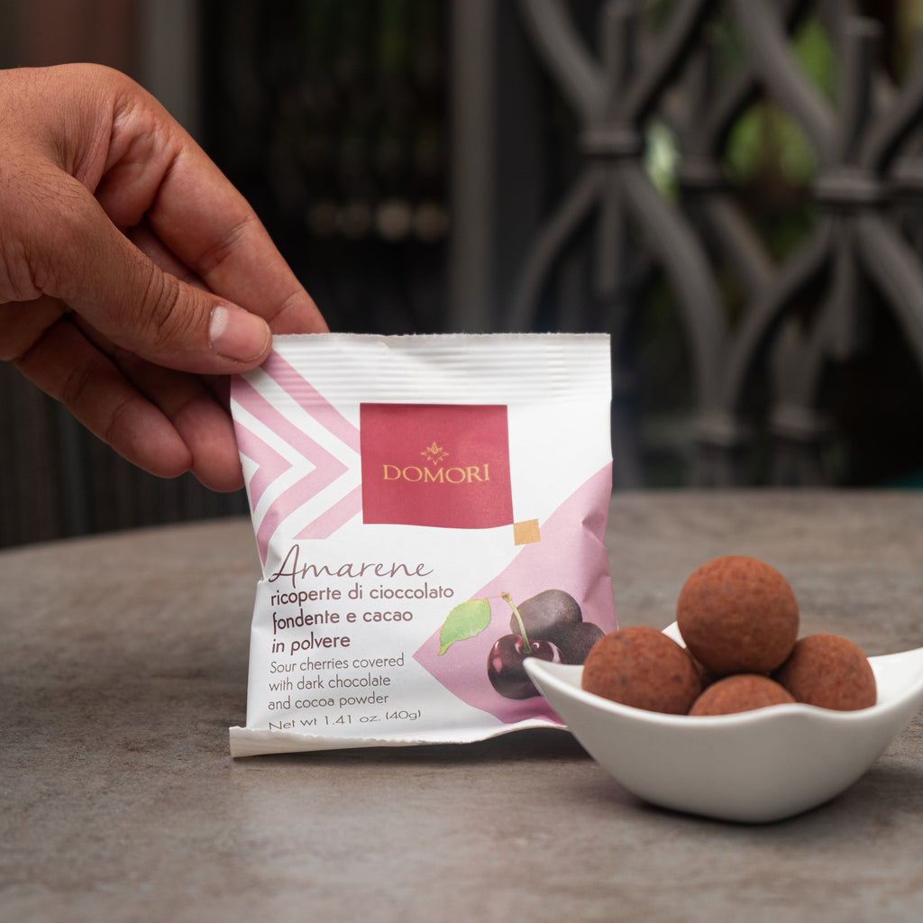 Domori Dragees: pink white bag of amarene cherries in dark chocolate cocoa