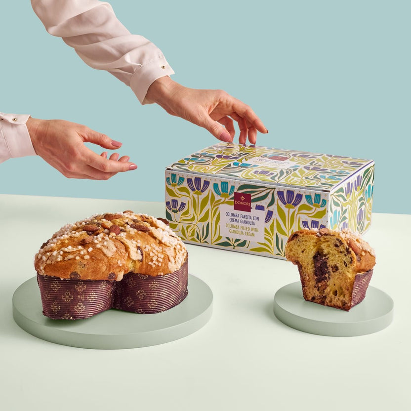 Heart-shaped Domori Colomba cake with gianduja cream has a golden-brown crust topped with almonds and sugar crystals