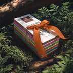 Six Domori bars tied with an orange ribbon among ferns.