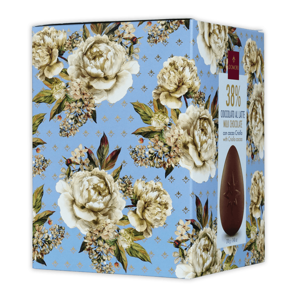 Rectangular domori easter egg milk chocolate box with 38% cocoa on a light blue floral cream and green background
