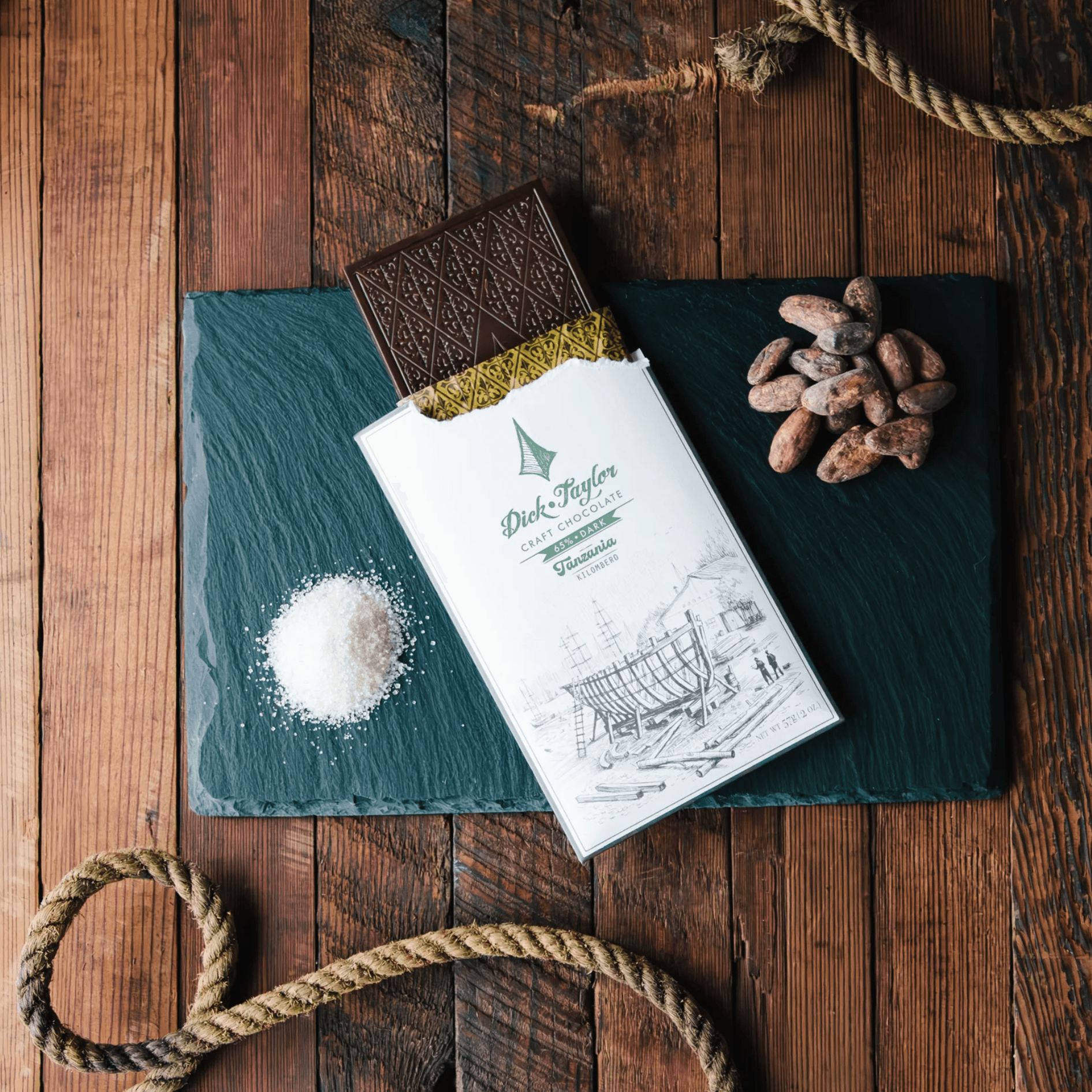 Dick Taylor Tanzania 65% dark chocolate bar, partially unwrapped
