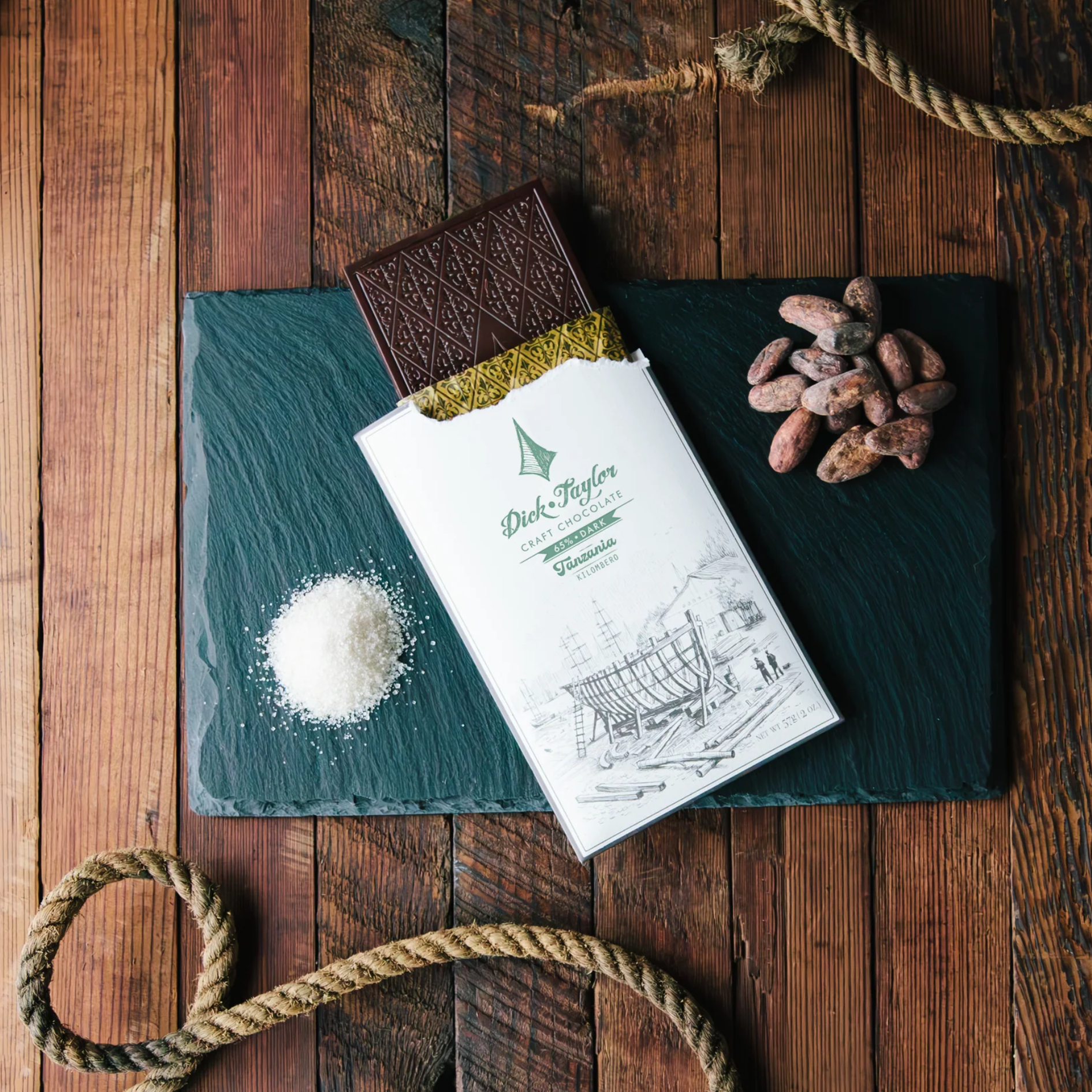 Dick Taylor Tanzania 65% dark chocolate bar, partially unwrapped