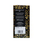 The back of a Feliu Chocolate wrapper, black with a yellow bird and floral pattern, showing ingredients and a barcode.