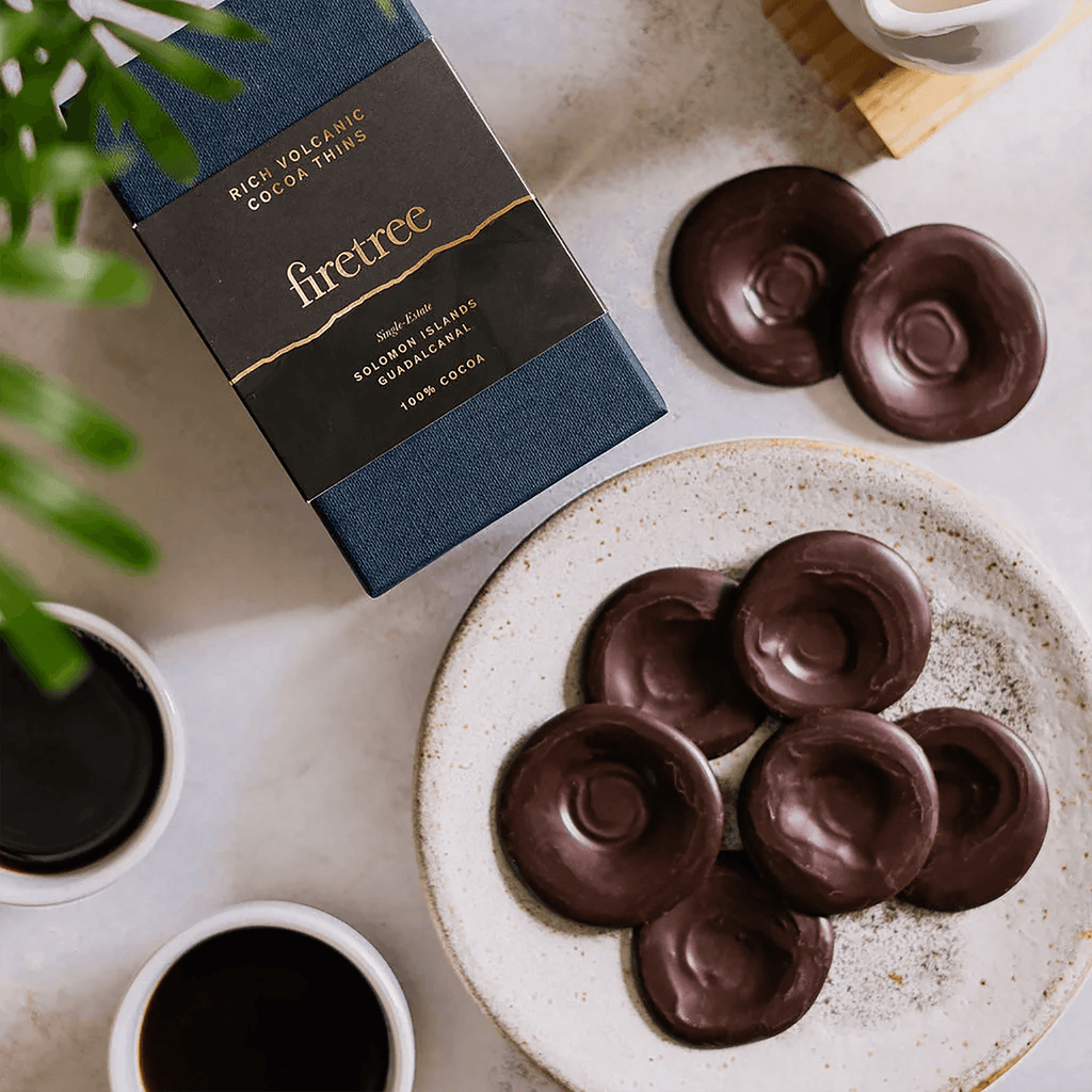 Firetree Thins Dark Solomon Islands 100% chocolate discs on plate with packaging