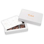 Fjåk white tjåk box with geometric lid, gold lettering, dark chocolates, 6 pc caramels