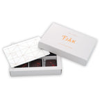 Fjåk Chocolate Coated Raspberry Caramels in white geometric box with gold foil